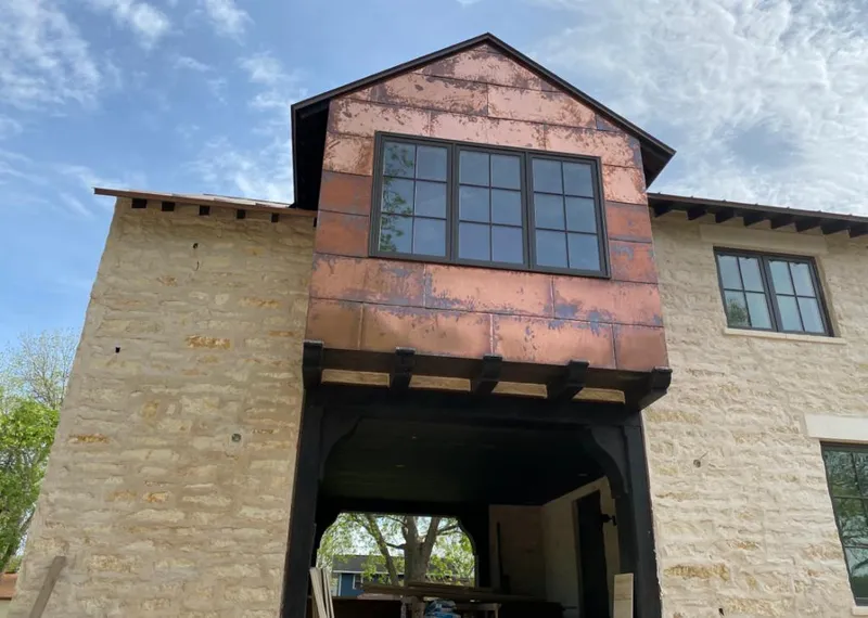 Copper metal panel facade on a stone building for Skylight Installation in Norwell